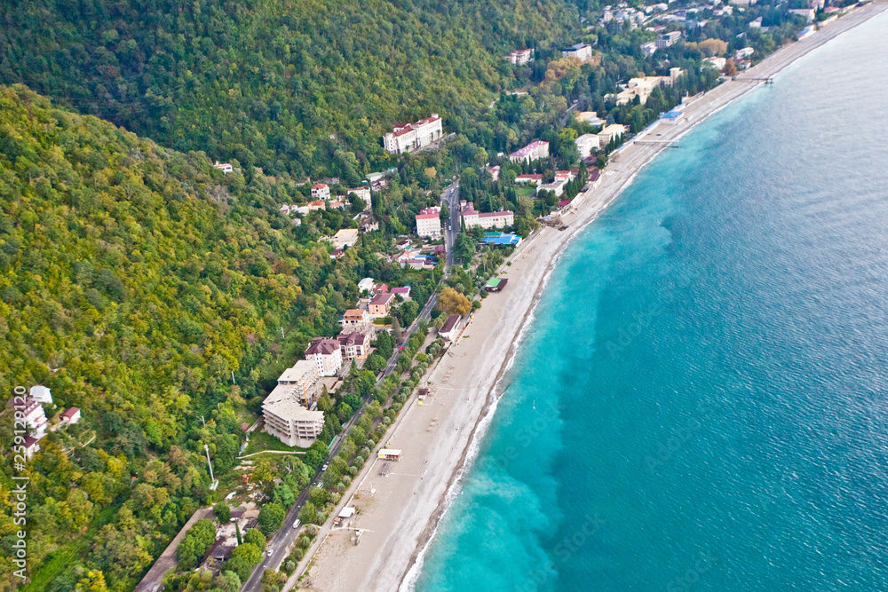 Beautiful green hills with hotels and hotels by the sea, rich bright colors. Aerial view  in Abkhazia