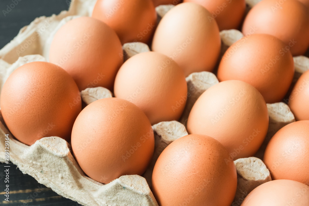 fresh chicken yellow orange eggs in a beige paper box closeup fresh chicken yellow orange eggs in a beige paper box closeup