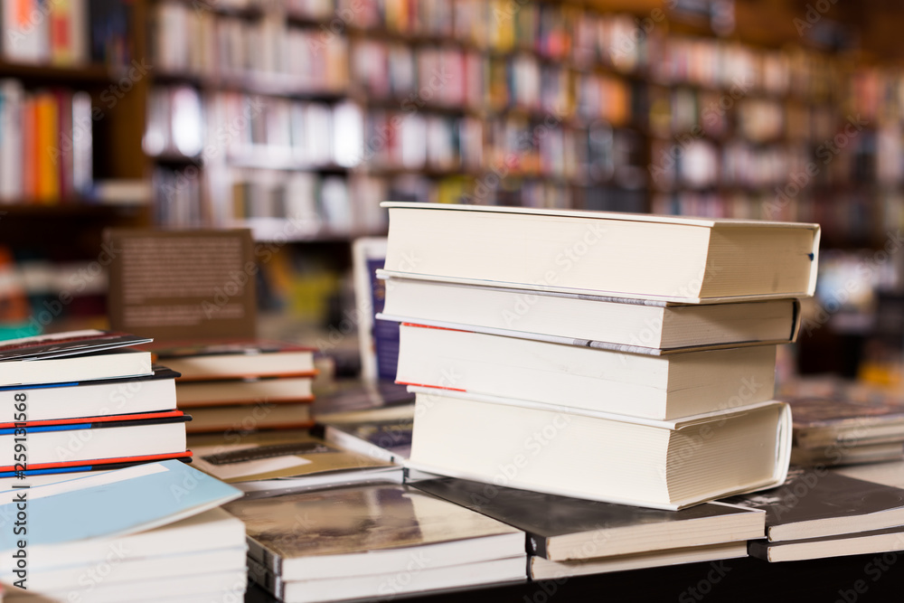 Fototapeta premium stack of books lying on table in bookstore