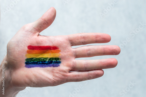 rainbow flag on the palm of a man. Concept symbol LGBT