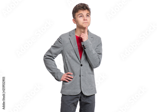 Portrait of young caucasian Teen Boy in suit, isolated on white background. Thoughtful Funny Teenager. Young Student - ponder and dreaming, isolated on white background. Back to School concept.