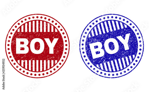 Grunge BOY round stamp seals isolated on a white background. Round seals with grunge texture in red and blue colors. Vector rubber imprint of BOY text inside circle form with stripes.
