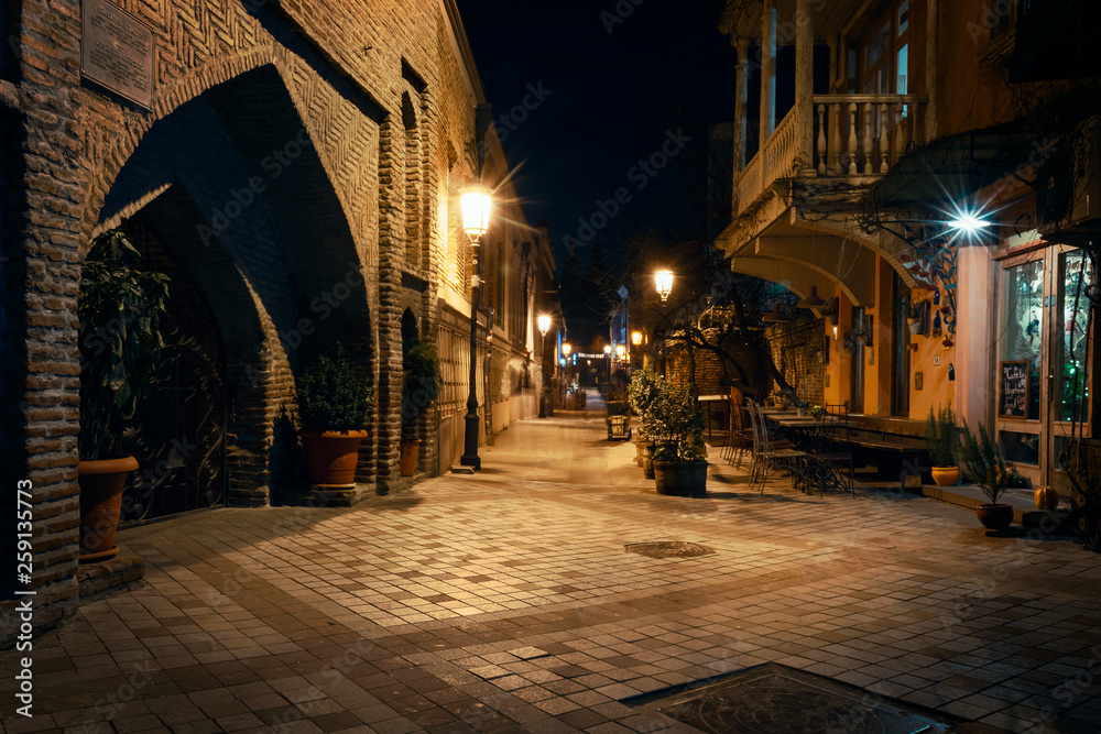 Georgia, Tbilisi - 05.02.2019. - Night view from the streets of Tbilisi old town. Ancient architecture and street lights