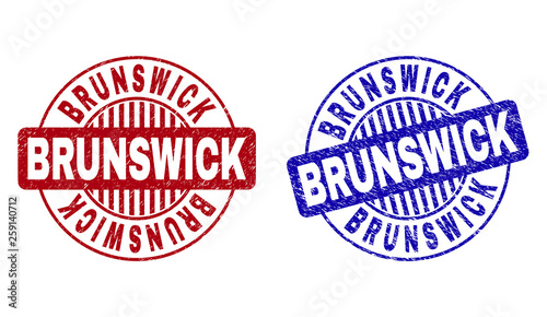 Grunge BRUNSWICK round stamp seals isolated on a white background. Round seals with grunge texture in red and blue colors. Vector rubber imprint of BRUNSWICK tag inside circle form with stripes.