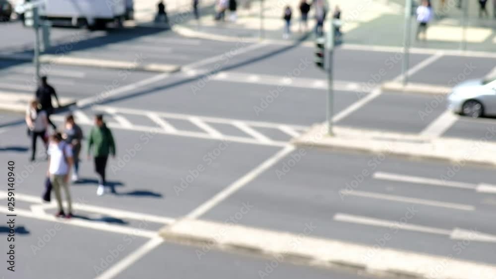 Blurred view of moving cars and people walking across the street, people cross the road, blurred background.. Blurred view of moving cars and people walking across the street, people cross the road, blurred background..