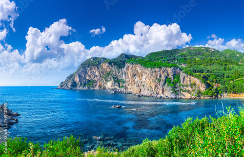 Fototapeta Naklejka Na Ścianę i Meble -  Beautiful summer panoramic seascape. View of Paleokastritsa famous beach in close bay with crystal clear azure water on Corfu island, Ionian archipelago, Greece.