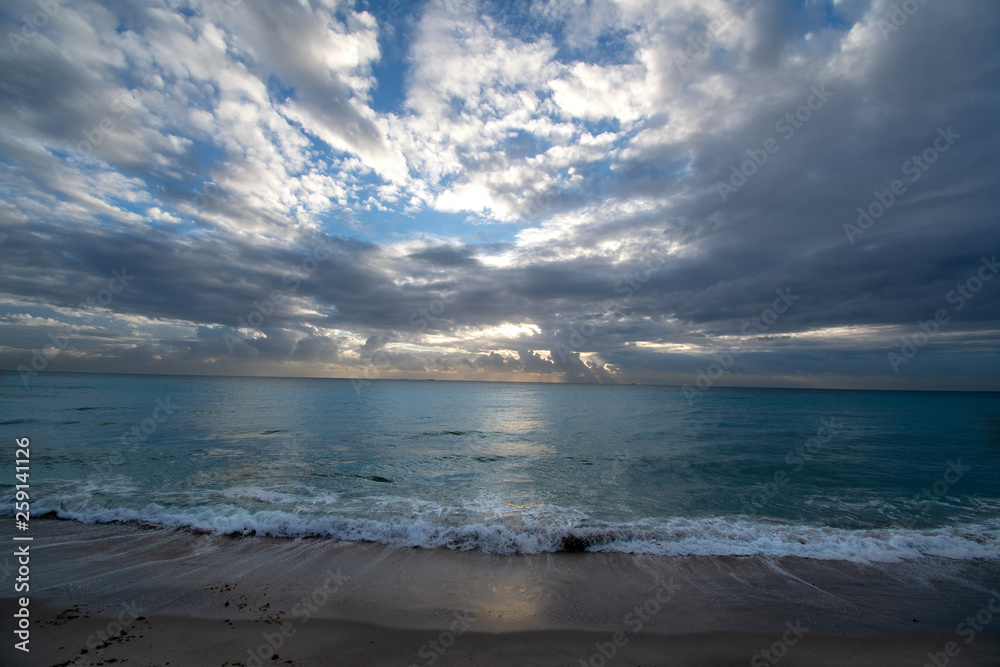 Sunrise over the ocean in Miami Beach with a cloudy sky