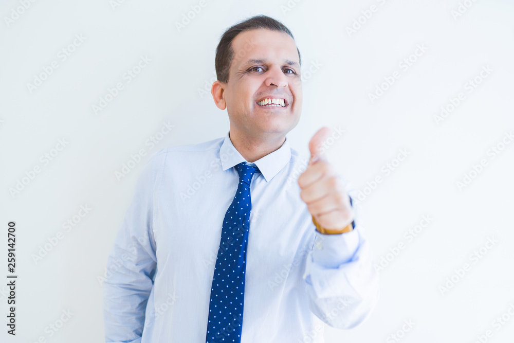 Middle age man doing postive gesture with thumbs up smiling to the camera