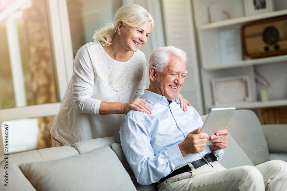 Senior couple using digital tablet at home Senior couple using digital tablet at home