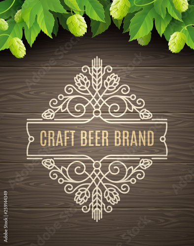 Vector illustration - Green hops and flourishes beer emblem on a wooden plank background.