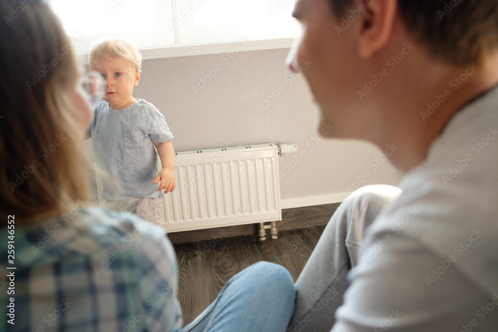 The child plays with his parents in the nursery. Happy family concept The child plays with his parents in the nursery. Happy family concept
