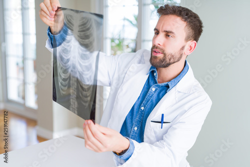 Doctor man looking at x-ray radiography doing body examination