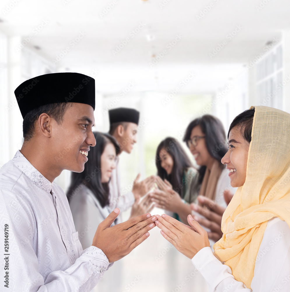 portrait of asian man and woman greeting in muslim traditional way touching tip of finger portrait of asian man and woman greeting in muslim traditional way touching tip of finger