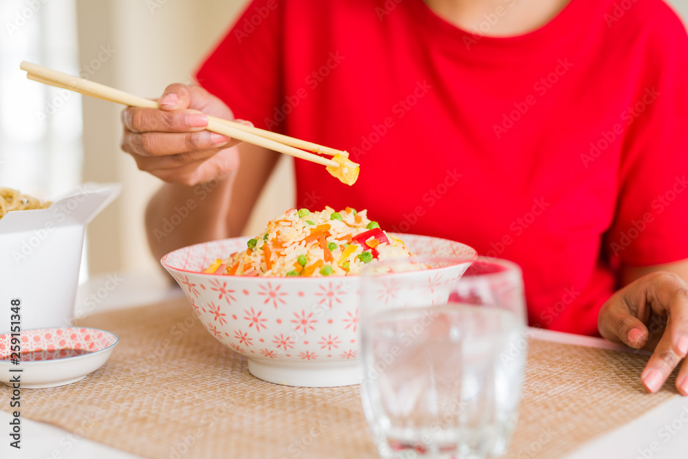Close up of woman eating asian rice using chopsticks Close up of woman eating asian rice using chopsticks