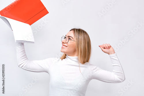 Studio portrait of happy young businesswoman wearing white blouse and round trendy eyeglasses with red folder in hand  with blank copy space for your text.