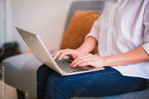 Close up of woman's hands typing on laptop keyboard at home - Image