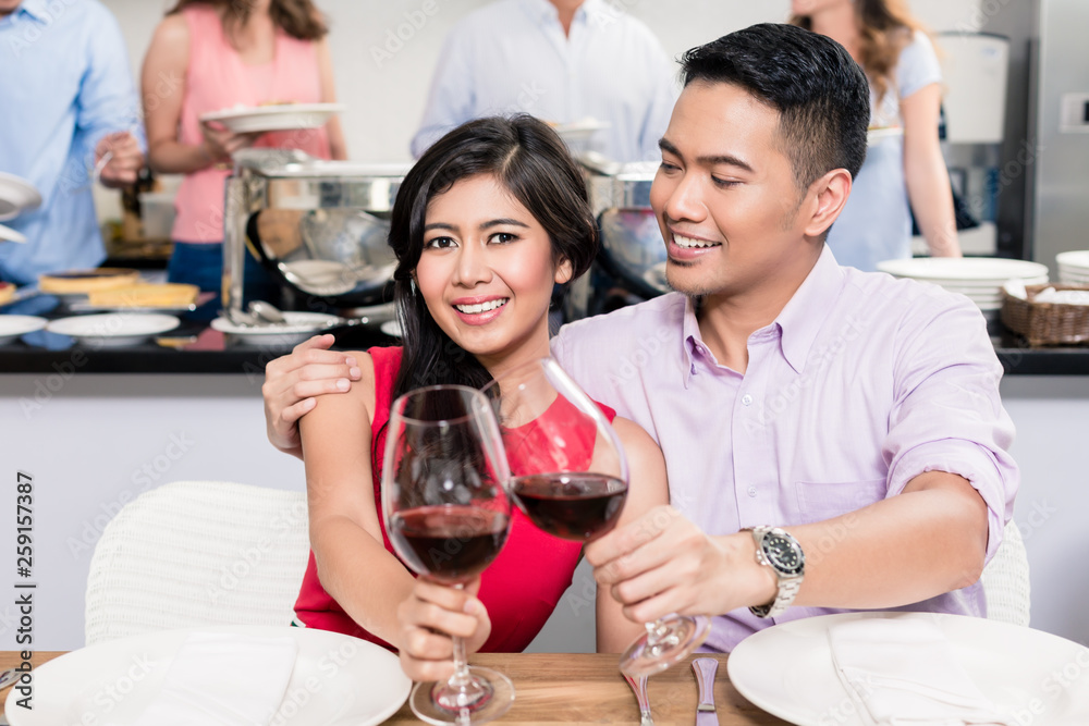 Young happy couple toasting red wine glasses Young happy couple toasting red wine glasses
