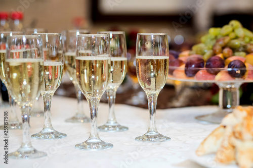 out catering, glasses with white and red wine, champagne, whiskey, juice and mineral water are on table for the guests of event