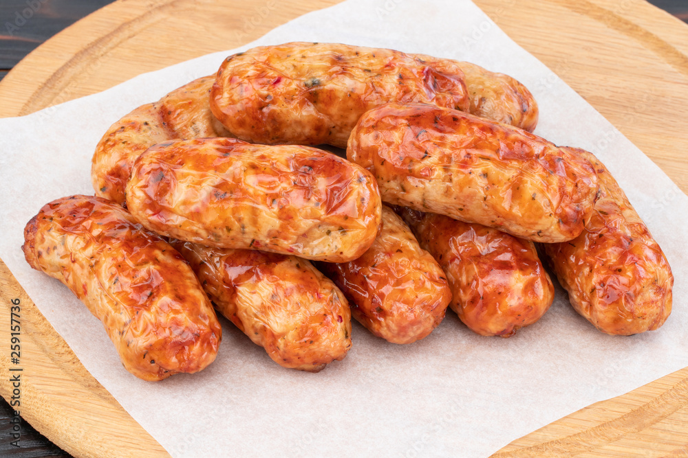 Tasty grilled sausage on the wooden background Tasty grilled sausage on the wooden background