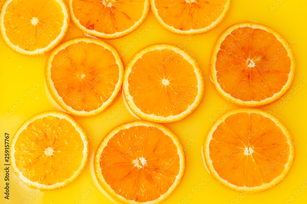 Top view of red orange slices in juice as background Top view of red orange slices in juice as background