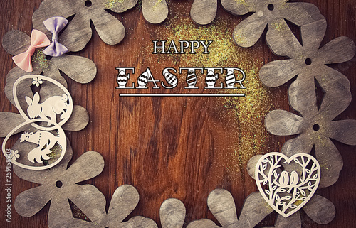 Easter card, on a background of natural wood with bows, flowers and Easter decorations.