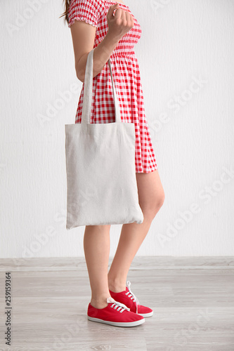 Young woman with eco bag indoors