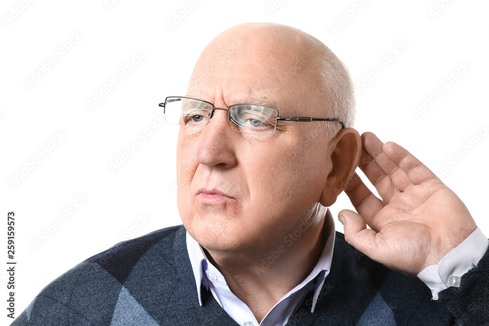 Senior man with hearing problem on white background Senior man with hearing problem on white background