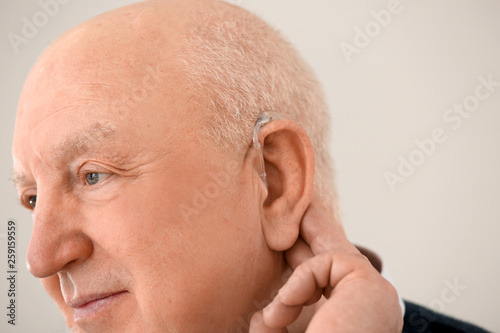 Senior man with hearing aid...
