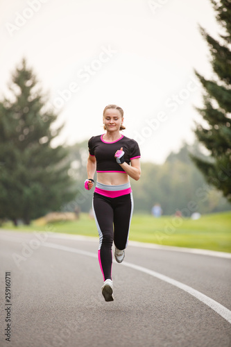 sport girl making exercises outdoors. Young sport woman in a park. Sport and fitness on open air