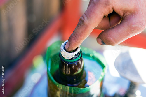 smoking cannabis of a bottle  medical smoking weed homemade bong rasta Man sets fire to weed use marijuana