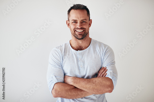 Mature entrepreneur standing with arms crossed on a white backgr