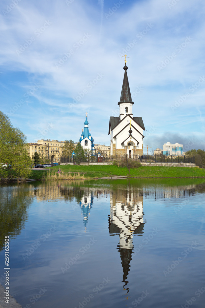 Saint Petersburg. A pond with a beautiful reflection of the churches of St. George the Victorious and the Nativity of Christ in Pulkovo Park in spring day