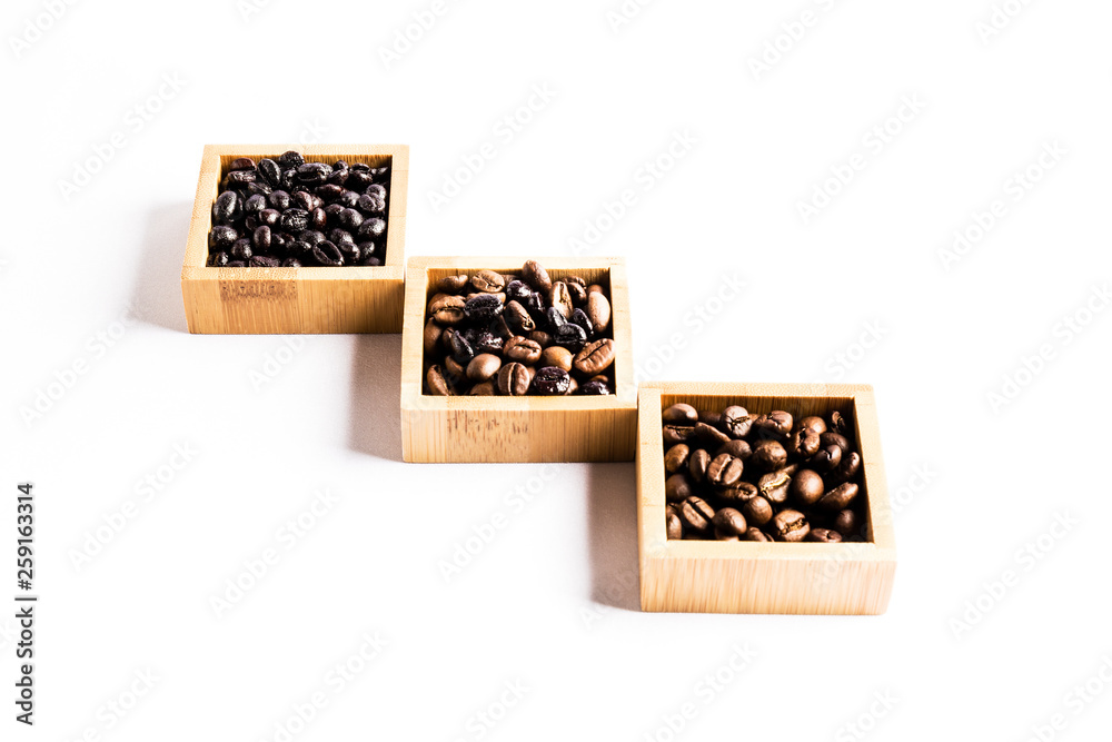 Three groups of different coffee beans in wooden bowls Three groups of different coffee beans in wooden bowls
