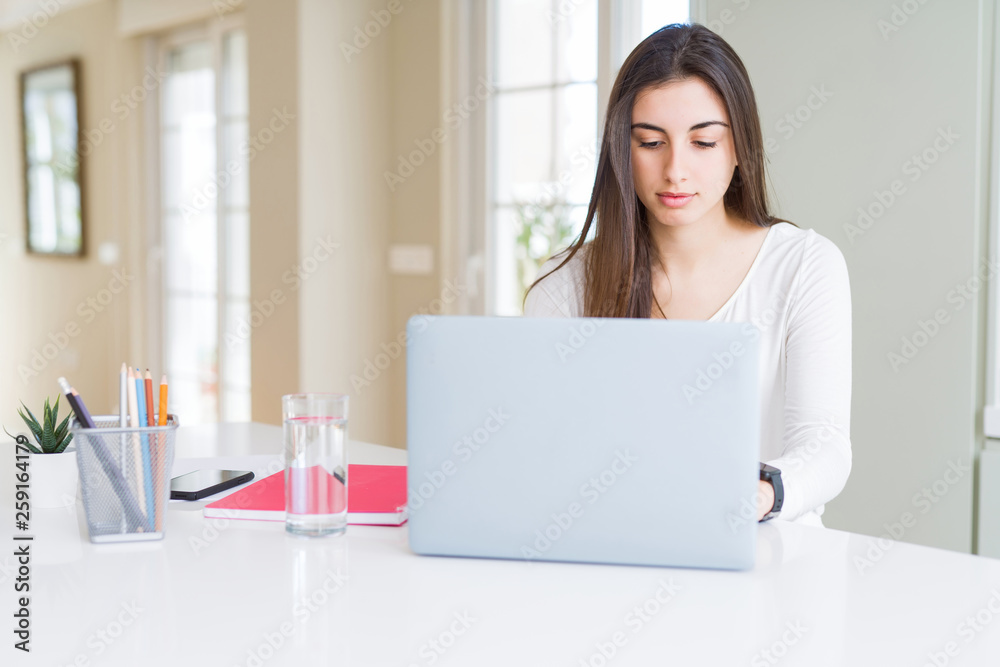 Young beautiful woman concentrated working using computer laptop Young beautiful woman concentrated working using computer laptop