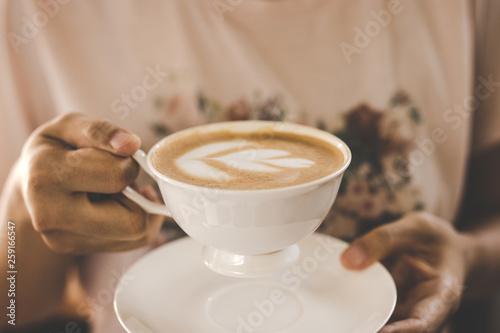 female hands holding coffee latte art