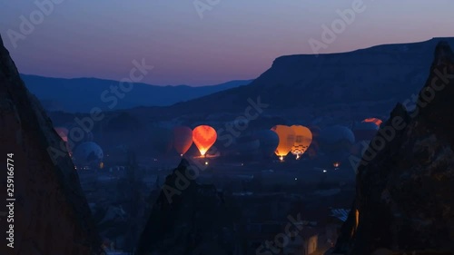 Hot air baloons preparing for take off. Famous sightseeing Cappadocia. Lights of air balloons.
