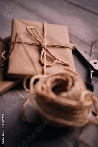 Gift packages of kraft paper, rope and scissors