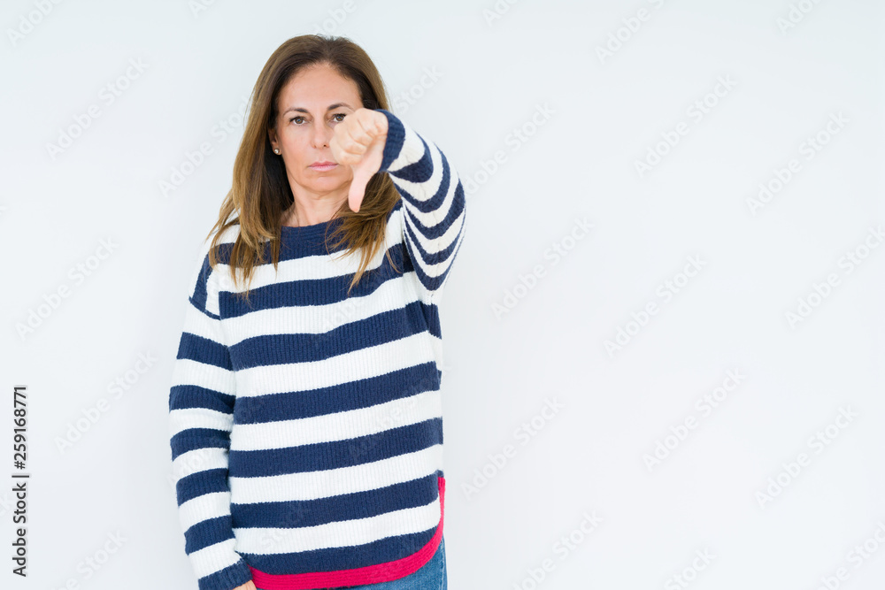 Beautiful middle age woman wearing navy sweater over isolated background looking unhappy and angry showing rejection and negative with thumbs down gesture. Bad expression. Beautiful middle age woman wearing navy sweater over isolated background looking unhappy and angry showing rejection and negative with thumbs down gesture. Bad expression.