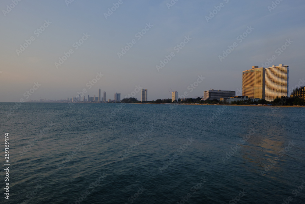 Fototapeta premium View of the sunset city from the pier in Pattaya