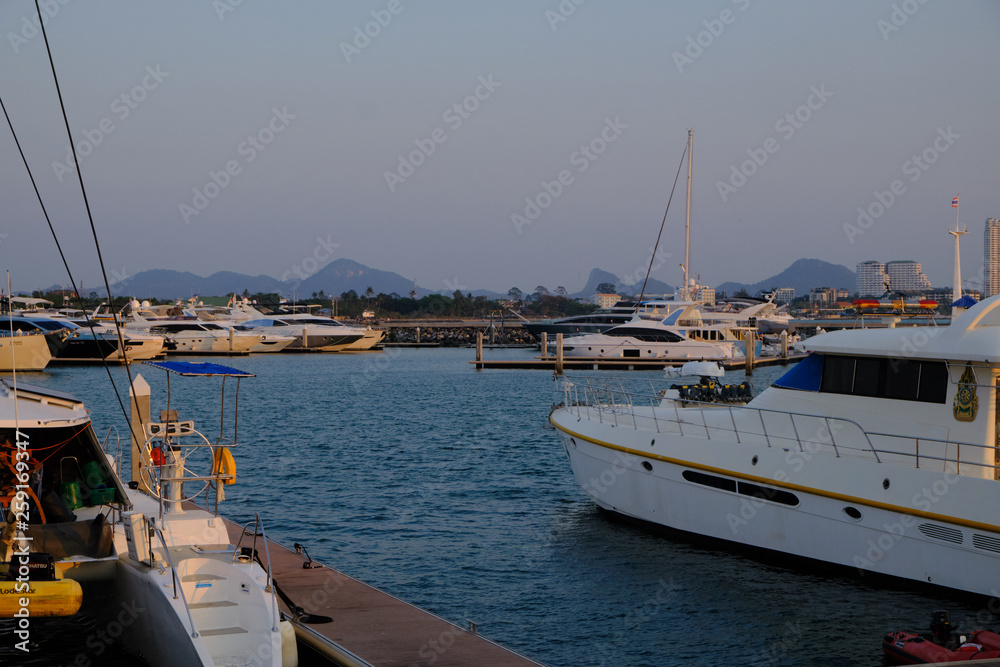 Fototapeta premium View of the sunset city from the pier in Pattaya