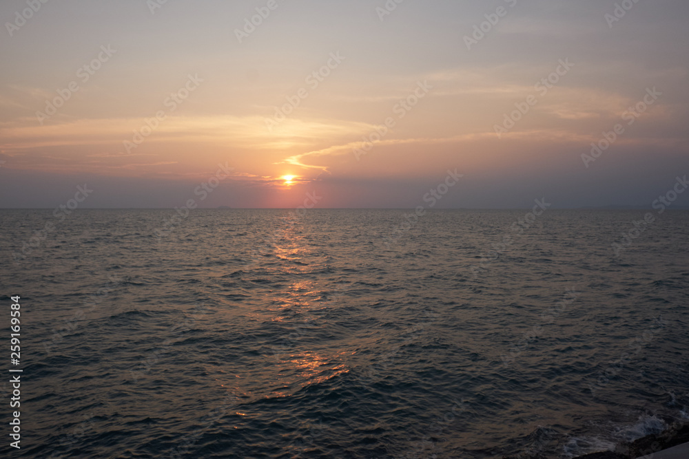 Fototapeta premium View of the sunset city from the pier in Pattaya