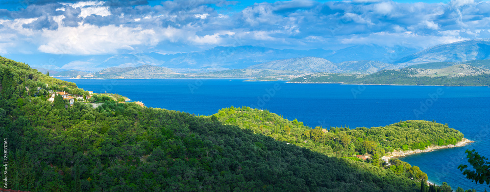 Beautiful summer panoramic seascape.  Green slopes in close bays with crystal clear azure water. Coastline of north part Corfu island, Ionian archipelago, Greece.