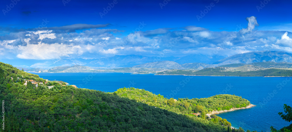 Beautiful summer panoramic seascape.  Green slopes in close bays with crystal clear azure water. Coastline of north part Corfu island, Ionian archipelago, Greece.