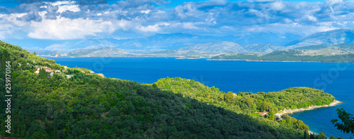 Beautiful summer panoramic seascape. Green slopes in close bays with crystal clear azure water. Coastline of north part Corfu island, Ionian archipelago, Greece.