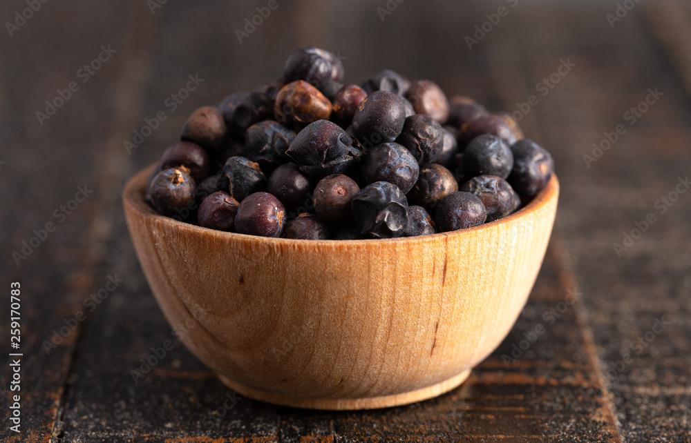 Bowl Full of Dried Juniper Berries on a Wooden Table Bowl Full of Dried Juniper Berries on a Wooden Table
