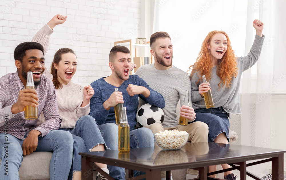 Happy football fans watching match on tv and celebrating victory Happy football fans watching match on tv and celebrating victory