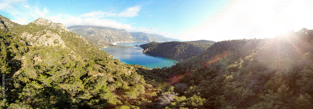 Sunrise over a turquoise lagoon surrounded by mountains and forest at sunrise, Fethiye, Turkey