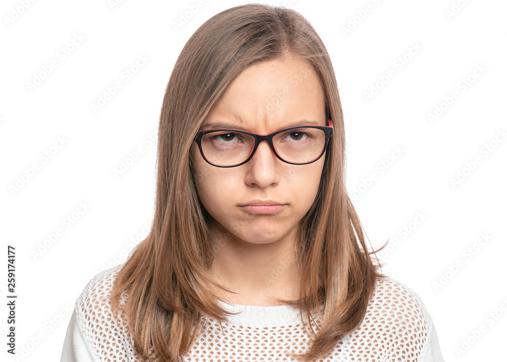 Unhappy or offended Beautiful caucasian Teen Girl in eyeglasses, isolated on white background. Dissatisfied Schoolgirl looking away. Sad child - close-up portrait.