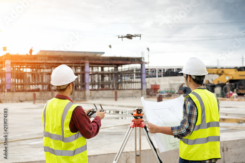 Engineer surveyor working with theodolite at construction site
