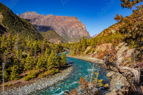 View of the blue mountain river Nepal flowing into the gorge